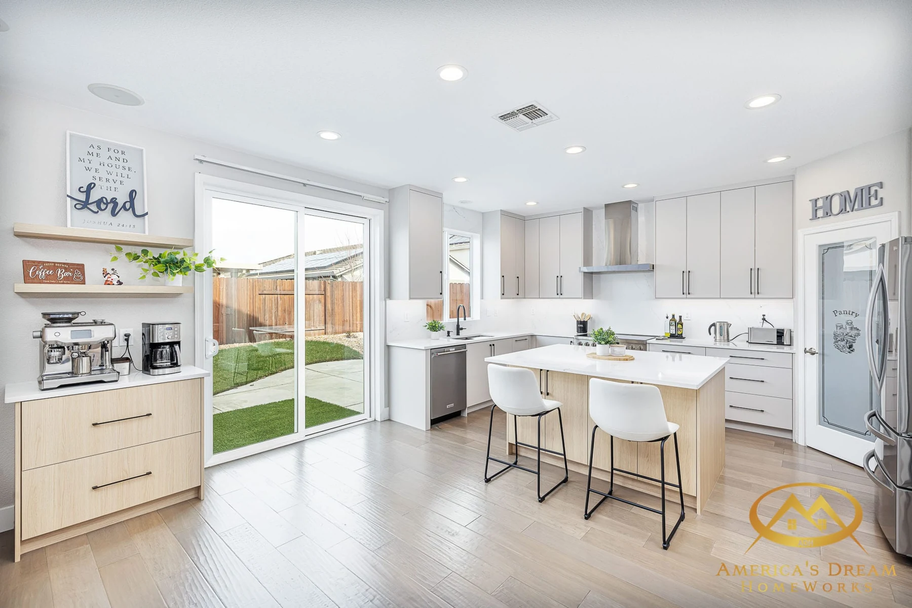 Bright white and oak kitchen with a breakfast island, garden doors, and a coffee station
